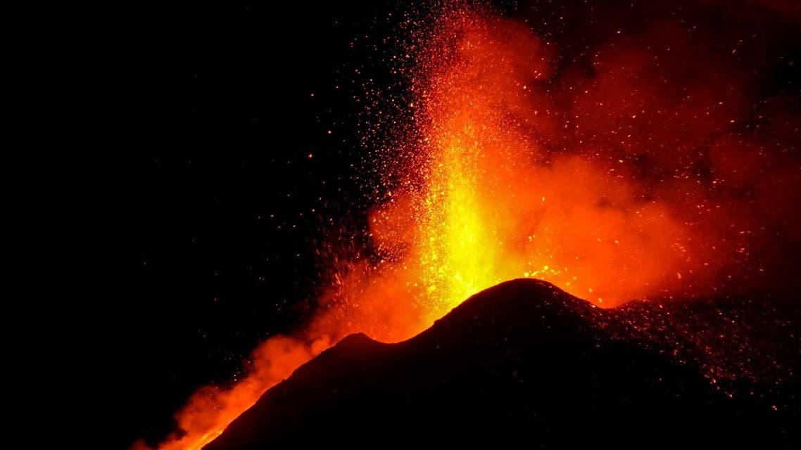 Large streams of red hot lava shoot into the night sky as Mount Etna, Europe's most active volcano, continues to erupt, , as seen from the village of Fornazzo, Italy, on February 22, 2021. (Reuters)