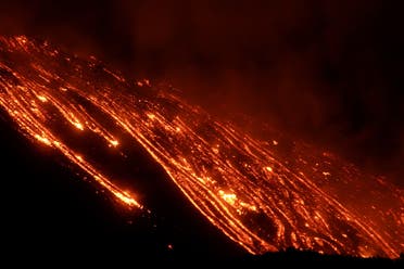 Streams of red hot lava flow as Mount Etna, Europe’s most active volcano, continues to erupt, seen from Zafferana Etnea, Italy, on February 21, 2021. (Reuters)