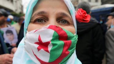 A demonstrator wearing a protective face mask with the Algerian flag takes part in a protest to mark the second anniversary of a mass protest movement demanding political change, in Algiers, Algeria February 22, 2021. (Reuters)