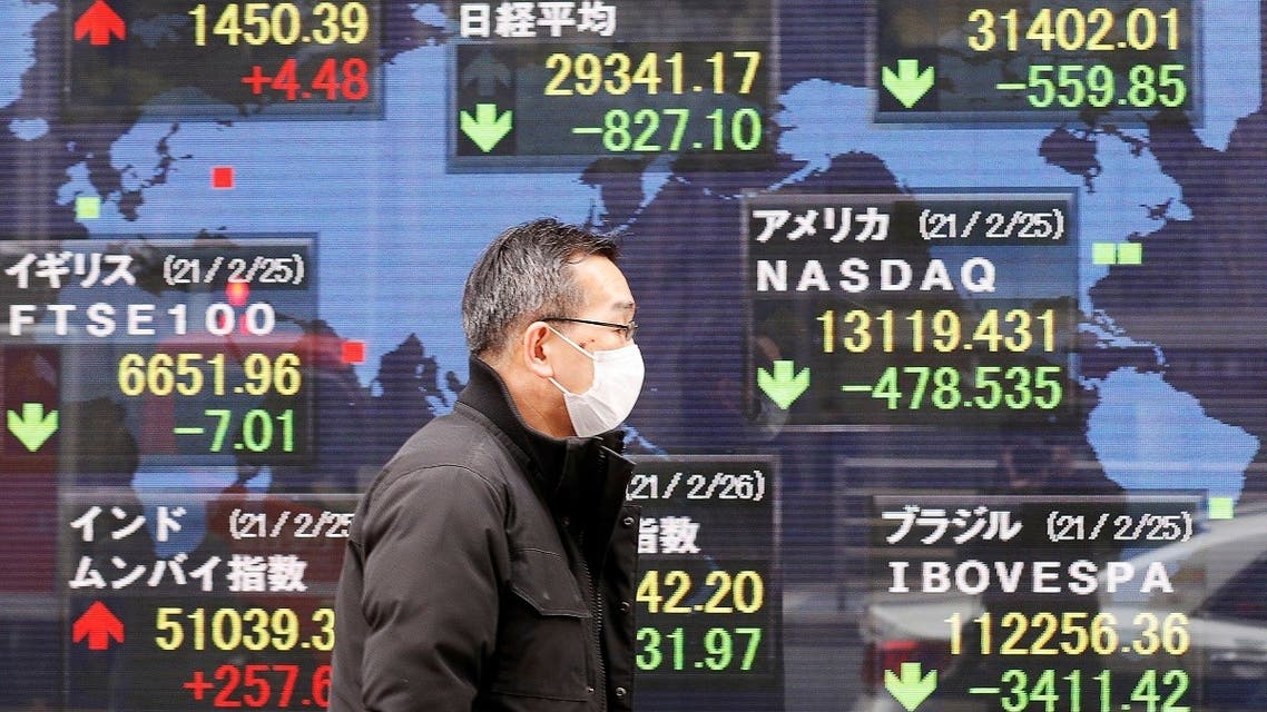 A man walks past a stock quotation board at a brokerage in Tokyo, Japan, on February 26, 2021. (Reuters)