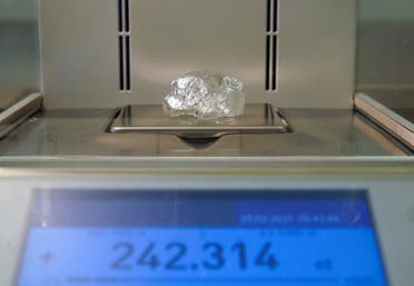 A rare 242-carat rough diamond, which will be offered at the 100th international auction of Russian state-controlled diamond producer Alrosa, is placed on scales during a presentation in Moscow, Russia February 25, 2021. (Reuters)