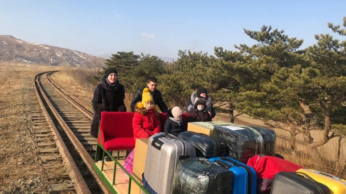 Russian diplomats and family members use a hand-pushed rail trolley to leave North Korea amid the coronavirus disease restrictions while crossing the demarcation line between North Korea and Russia. (Reuters)