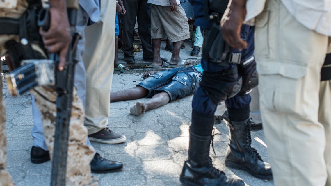 The body of a dead inmate lies on the pavement by the Croix-des-Bouquets prison from where many prisoners escaped and where several people were killed, in Croix-des-Bouquets, suburb of the Haitian capital, on February 25, 2021. Multiple people were killed February 25 in Haiti, including the director of a prison in the suburbs of capital Port-au-Prince, after several inmates escaped, police said. (File photo: AFP)