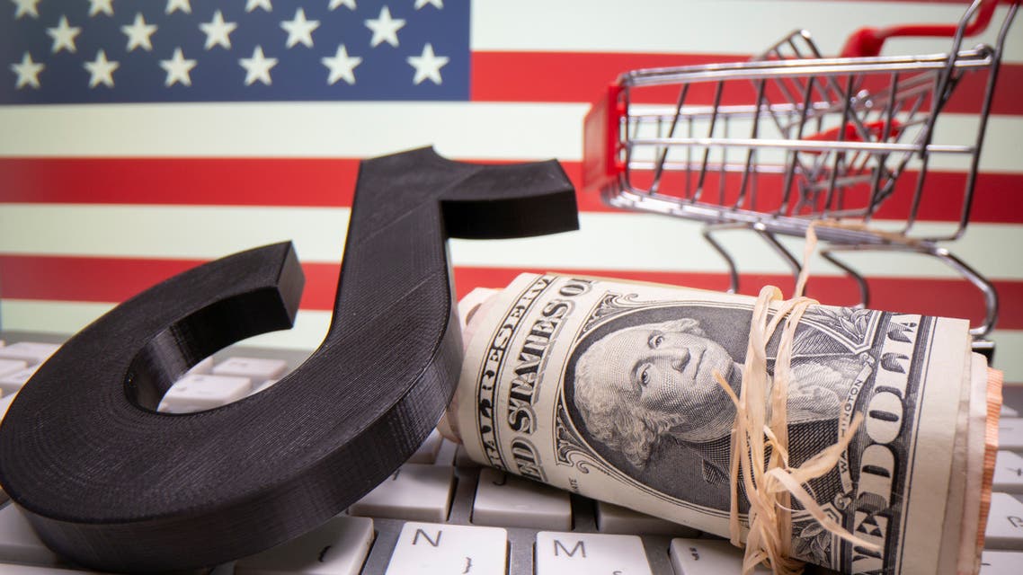 A 3D printed Tik Tok logo, dollar banknotes, shopping cart and keyboard are seen in front of U.S. flag in this illustration taken, October 6, 2020. Picture taken October 6, 2020. REUTERS/Dado Ruvic/Illustration