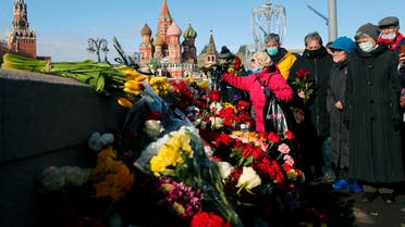 A woman lays flowers near the place where Russian opposition leader Boris Nemtsov was gunned down, in Moscow, Russia, Saturday, February 27, 2021. (AP)