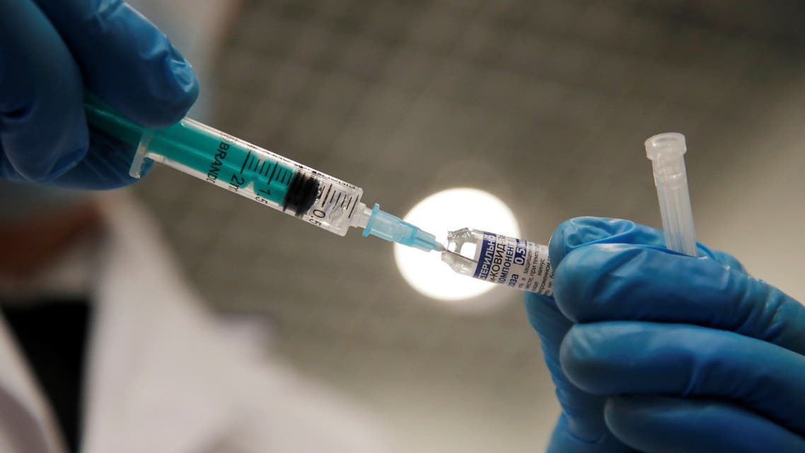 A medical worker holds a syringe with Sputnik V (Gam-COVID-Vac) vaccine against the coronavirus disease (COVID-19) before administering an injection at a vaccination centre in a shopping mall in Saint Petersburg, Russia February 24, 2021. REUTERS/Anton Vaganov