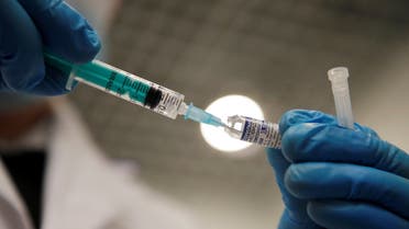 A medical worker holds a syringe with Sputnik V (Gam-COVID-Vac) vaccine against the coronavirus disease (COVID-19) before administering an injection at a vaccination centre in a shopping mall in Saint Petersburg, Russia February 24, 2021. (Reuters)