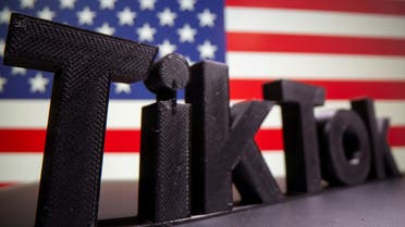 A 3D printed Tik Tok logo is placed on a keyboard in front of U.S. flag in this illustration taken October 6, 2020. Picture taken October 6, 2020. REUTERS/Dado Ruvic/Illustration