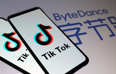 Tik Tok logos are seen on smartphones in front of a displayed ByteDance logo in this illustration. (Reuters)