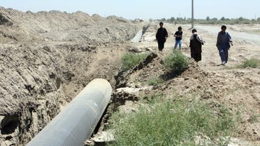 Iranians walk past a pipeline, in the south-eastern city of Zahedan 18 August 2007. Iranian President Mahmoud Ahmadinejad has allocated 50 trillion rials (over 5 billion dollars) to the south-eastern province of Sistan-Baluchestan for infrastructure projects in hopes of developing one of the country's poorest areas. AFP PHOTO/STR/ISNA