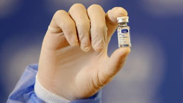 A Palestinian health worker displays a vial of Russia's Sputnik V vaccine as he prepares to vaccinate Matthias Schmale, UNRWA's Gaza director, against the coronavirus disease (COVID-19), in Gaza City February 24, 2021. REUTERS/Mohammed Salem
