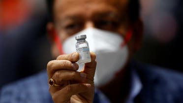 Indian Health Minister Harsh Vardhan holds a dose of Bharat Biotech's COVID-19 vaccine called COVAXIN, Jan. 16, 2021. (Reuters)