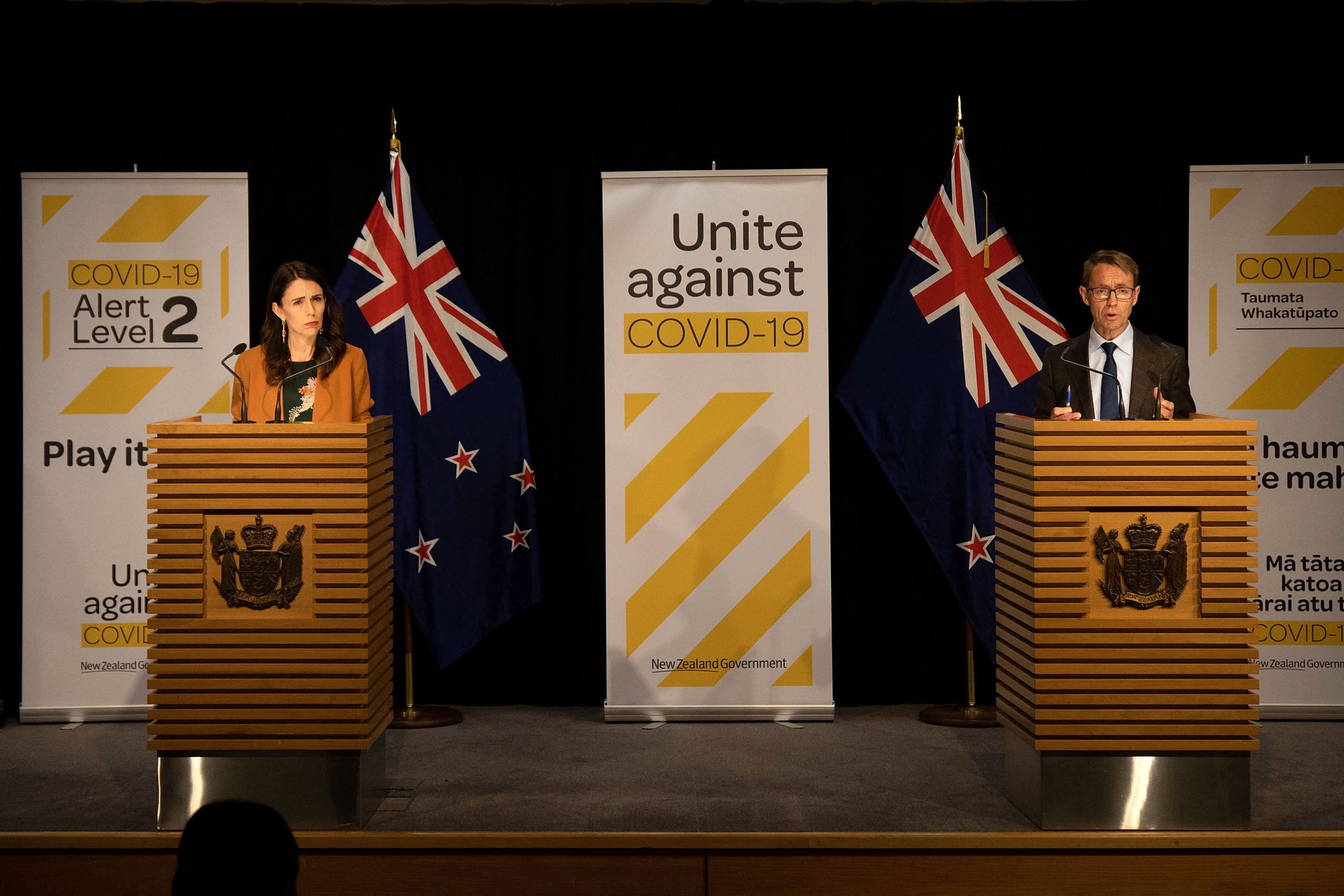 New Zealand's Prime Minister Jacinda Ardern (L) and New Zealand's health department director-general Ashley Bloomfield (R) take part in a press conference about the COVID-19 coronavirus at Parliament in Wellington on June 8, 2020. (File photo: AFP)