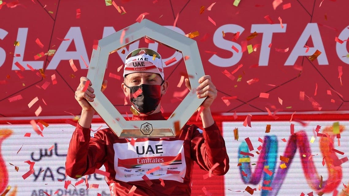 Tadej Pogacar of Team UAE Emirates celebrates on the podium after winning the UAE Cycling Tour from Yas Mall to Abu Dhabi Breakwater, on February 27, 2021. (AFP)
