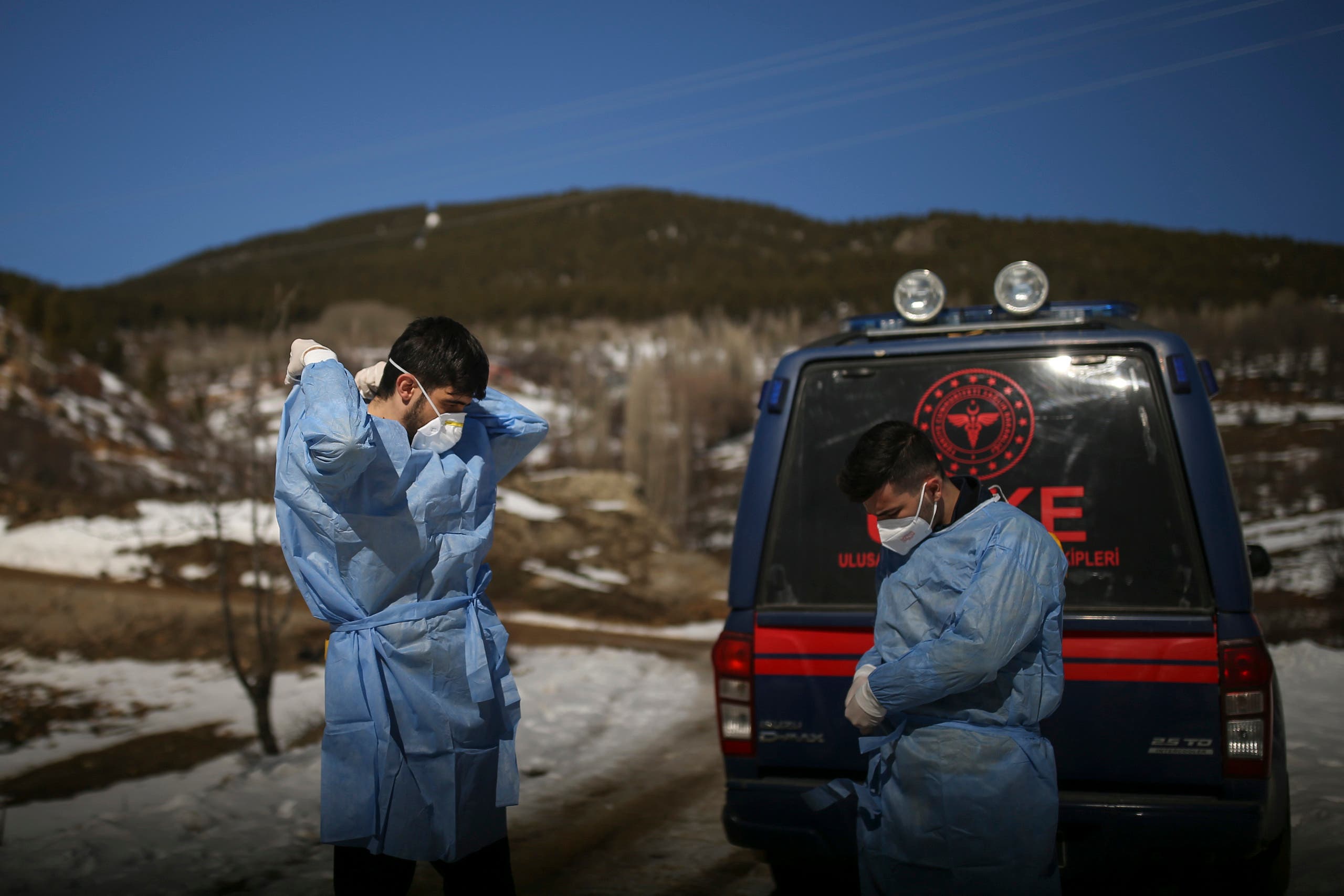 Dr. Yasin Kaya, left and health worker Yusuf Duran, right, members of the the Koyulhisar Public Health Center vaccination team, prepare to vaccinate 85-year-old Ibrahim Yigit in the isolated village of Gumuslu in the district of Sivas, central Turkey, Friday, Feb. 26, 2021. (AP)