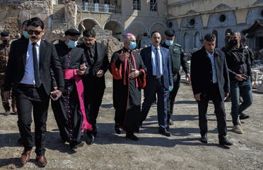 Archbishop of the Archeparchy of Mosul Najib Mikhael Moussa (C) and Father Raed Adel (C-L) and Niniveh Governor Najim al-Jabouri (C-R) escort the members of the Papal convoy during their visit to Iraq's northern city of Mosul, on February 23, 2021. (Zaid al-Obeidi/AFP)
