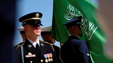 The flag of the Kingdom of Saudi Arabia flies in the face of a member of a US military honor guard at the Pentagon, Aug. 29, 2019. (Reuters)
