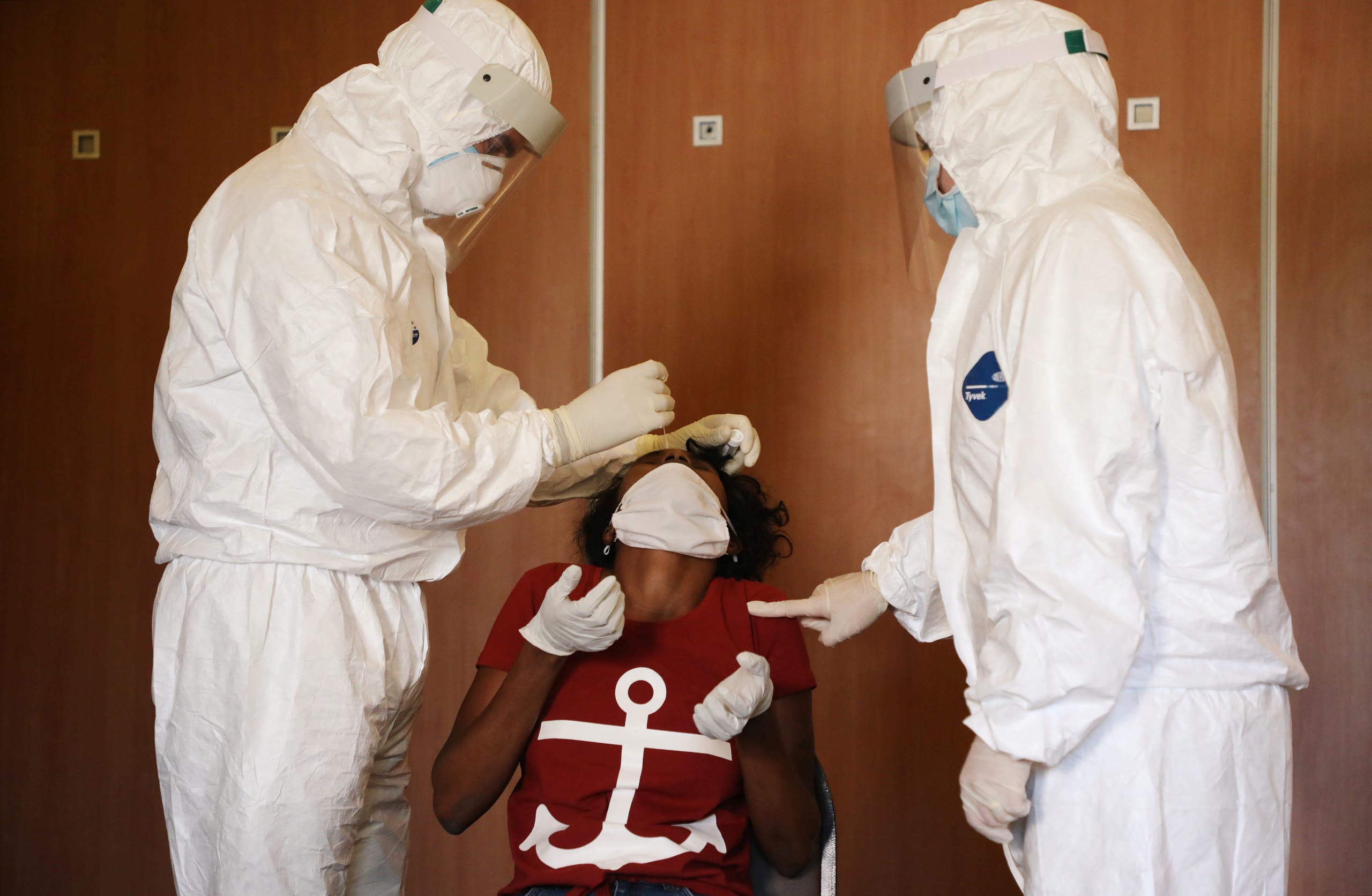 Health workers test a migrant domestic worker from Africa for the coronavirus disease (COVID-19) at a hotel, before she travels back to her country, in Beirut suburbs, Lebanon October 5, 2020. Picture taken October 5, 2020. (Reuters)