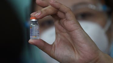 A health worker holds up a vial of China's Sinovac COVID-19 vaccine during the first phase of vaccinations for health workers at a hospital in Manila on March 1, 2021. (File photo: AFP)