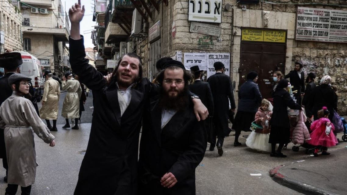 Orthodox Jewish men, are pictured during Purim celebrations,in the neighbourhood of Mea Shearim in Jerusalem, on February 28, 2021. (AFP)