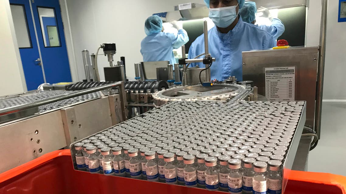 Production personnel perform the labeling operation of inspected vaccine vials inside the Incepta plant on the outskirts of Dhaka in Bangladesh Saturday Feb. 13, 2021. (AP Photo/Al-emrun Garjon)