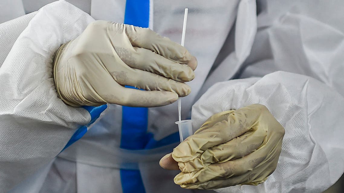 A health worker collects a swab of a passenger for a Covid-19 coronavirus test at a railway platform, in Mumbai on February 17, 2021. (AFP)