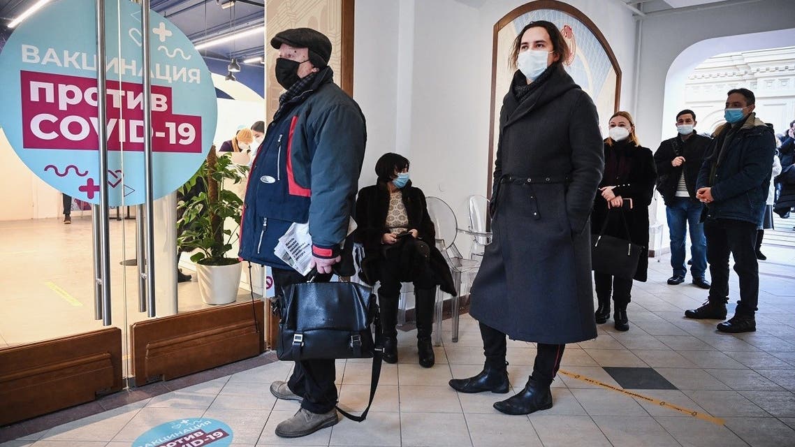 People queue to receive an injection of Russia’s Sputnik V (Gam-COVID-Vac) vaccine against the coronavirus at a vaccination point at the GUM department store in Moscow on January 18, 2021. (Alexander Nemenov/AFP)