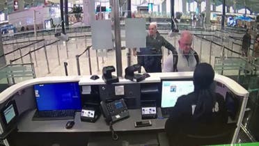 This handout video grab image released by The Istanbul Police Department on January 17, 2020, shows Michael Taylor (2R) and George Antoine Zayek (C) at passport control in Istanbul Airport, two men accused of helping fugitive businessman Carlos Ghosn escape via an Istanbul airport, as he fled a corruption trial in Japan. (AFP)
