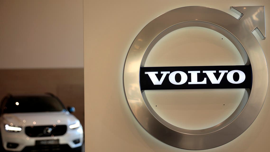In this February 6, 2020 file photo a Volvo car is parked behind the Volvo logo in the lobby of the company's corporate headquarters, in Brussels. (AP)