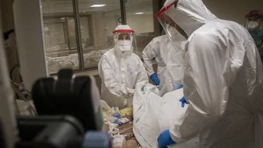 Doctors assist a COVID-19 patient at the Kartal Dr. Lutii Kirdar Education and Research Hospital, Intensive Care Unit (ICU) on May 08, 2020 in Istanbul, Turkey. (AFP)