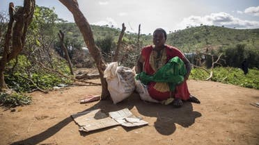 A refugee from Ethiopia sits next to a bag of rice donated by Kenyan officials at a camp in Moyale, Marsabit County, Kenya. (Courtesy UNHCR/Will Swanson)