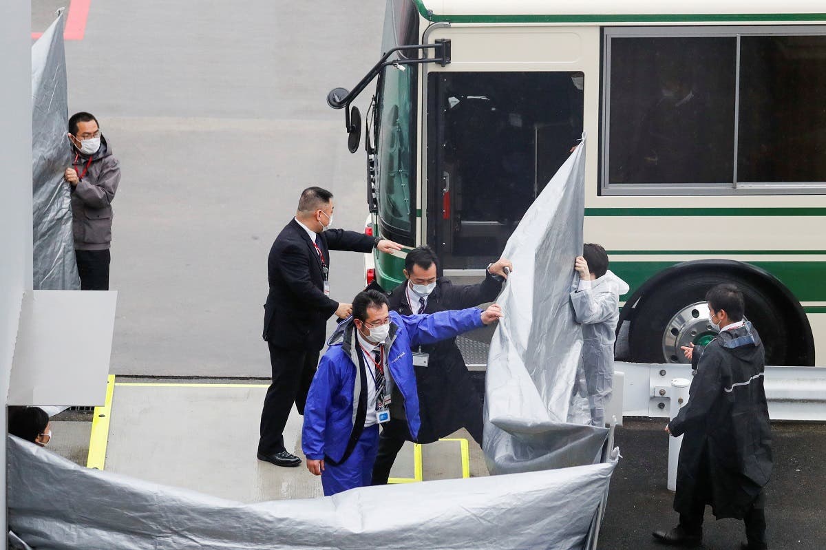 Japanese officers get prepared to escort US citizens Michael Taylor and his son Peter Taylor, suspected of helping former Nissan Motor Chairman Carlos Ghosn to escape to Lebanon, upon their arrival at Narita airport, following their extradition to Japanese Prosecutors, in Chiba, Japan, on March 2, 2021. (Reuters)