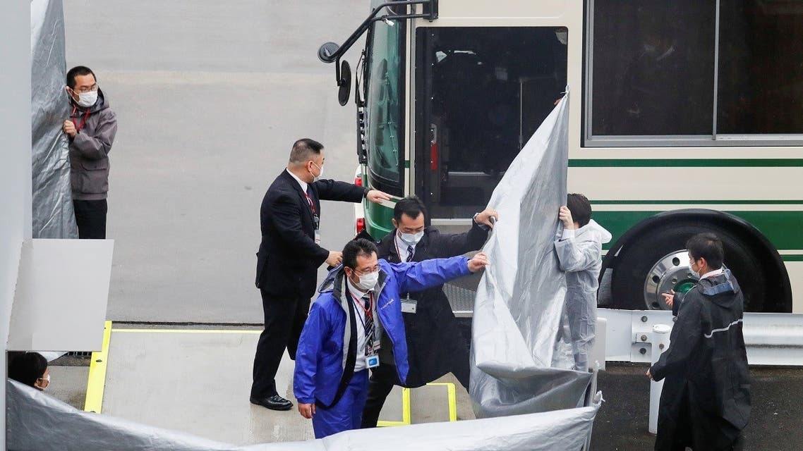 Japanese officers get prepared to escort US citizens Michael Taylor and his son Peter Taylor, suspected of helping former Nissan Motor Chairman Carlos Ghosn to escape to Lebanon, upon their arrival at Narita airport, following their extradition to Japanese Prosecutors, in Chiba, Japan, on March 2, 2021. (Reuters)