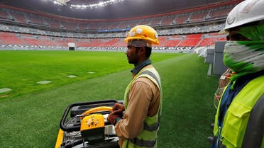 Workers are seen inside Al Bayt stadium, built for the upcoming 2022 FIFA World Cup. (Reuters)