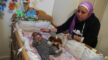 Yasmina al-Habbal, sits next to her Ghlaya, an orphan she sponsors, at her home in Cairo, Egypt February 22, 2021. Picture taken February 22, 2021. (Reuters/Hanaa Habib)