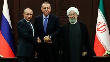 Turkish President Recep Tayyip Erdogan (C), Russian President Vladimir Putin (L) and Iranian President Hassan Rouhani (R) pose for photographs during a press conference following a trilateral meeting on Syria, in Ankara on September 16, 2019. (AFP)