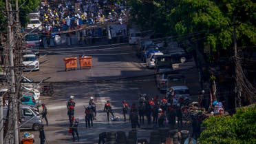 Anti-coup protesters standing behind barricades standoff with a group of police in Yangon, Myanmar Thursday, March 4, 2021. (AP)
