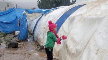 Internally displaced Syrian child plays with snow, at a camp in Northern Aleppo countryside Jan. 20, 2021. (Reuters)