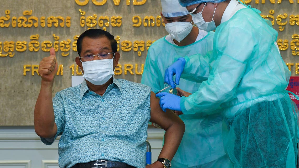 Cambodian Prime Minister Hun Sen gestures as he receives the AstraZeneca vaccine during a vaccination campaign against the Covid-19 coronavirus at Calmette hospital in Phnom Penh on March 4, 2021. (AFP)