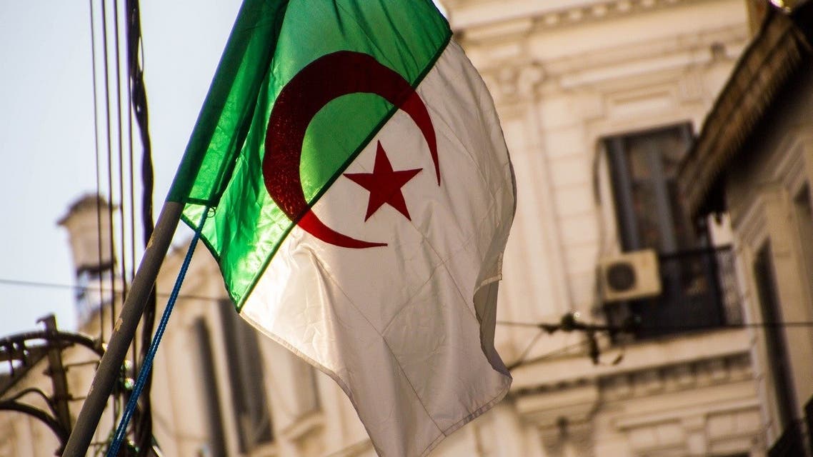 Buildings in the Algerian capital city, Algiers, are seen through an Algerian flag. (Peter Campbell via iStock)