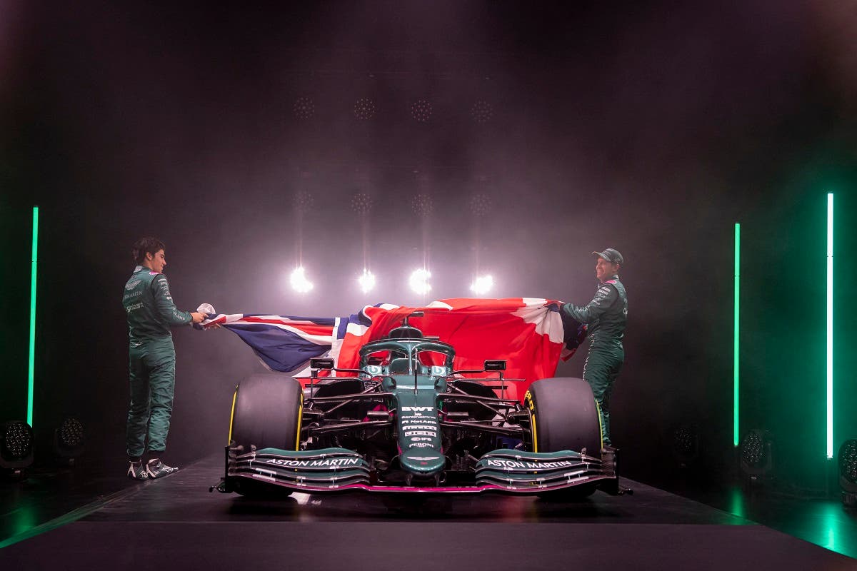 AMR21, Aston Martin Cognizant’s new car for the 2021 Formula One season, being unveiled by drivers Sebastian Vettel (R) and Lance Stroll (L) during a virtual launch event at their headquarters in Gaydon, central England. (AFP)
