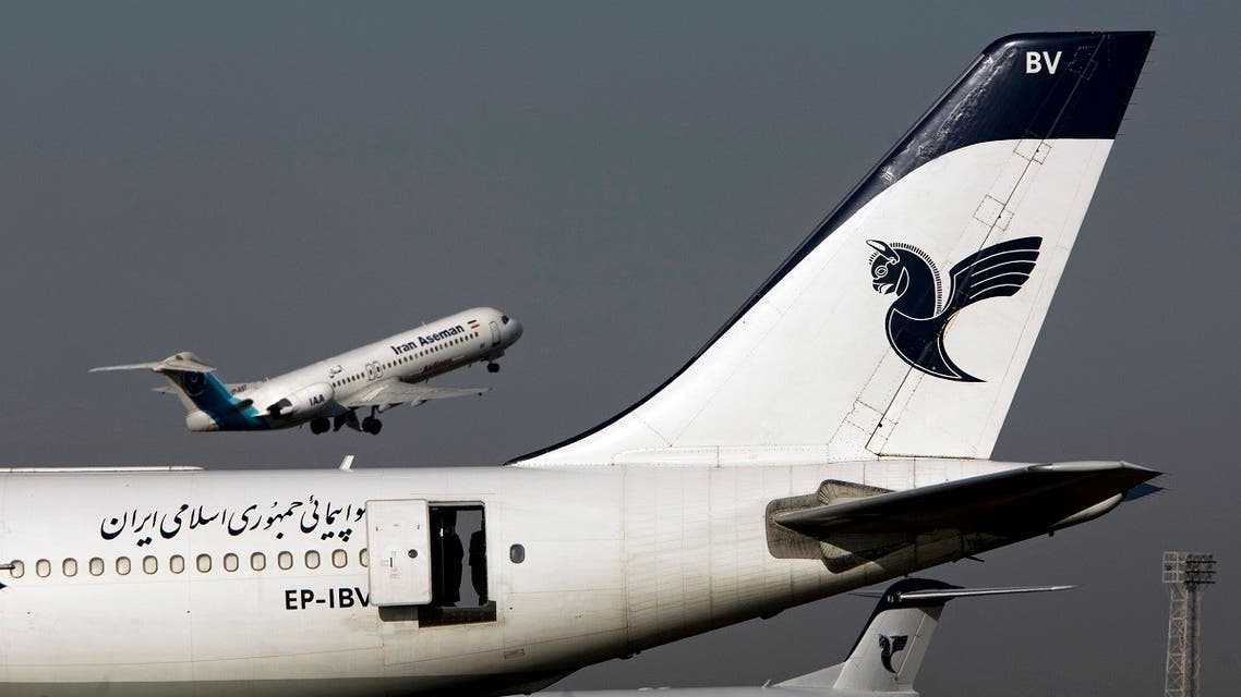 An Iranian Aseman Airlines' Fokker 100 takes off as an Iran Air aircraft is seen in the foreground at Tehran's international airport. (File photo: Reuters)