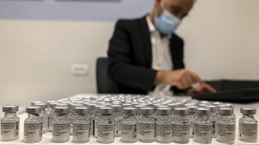 A health worker arranges vials of the Pfizer-BioNtech COVID-19 vaccine at the Clalit Health Services in the Palestinian neighbourhood of Beit Hanina, in the Israeli-annexed East Jerusalem on March 2, 2021. (AFP)