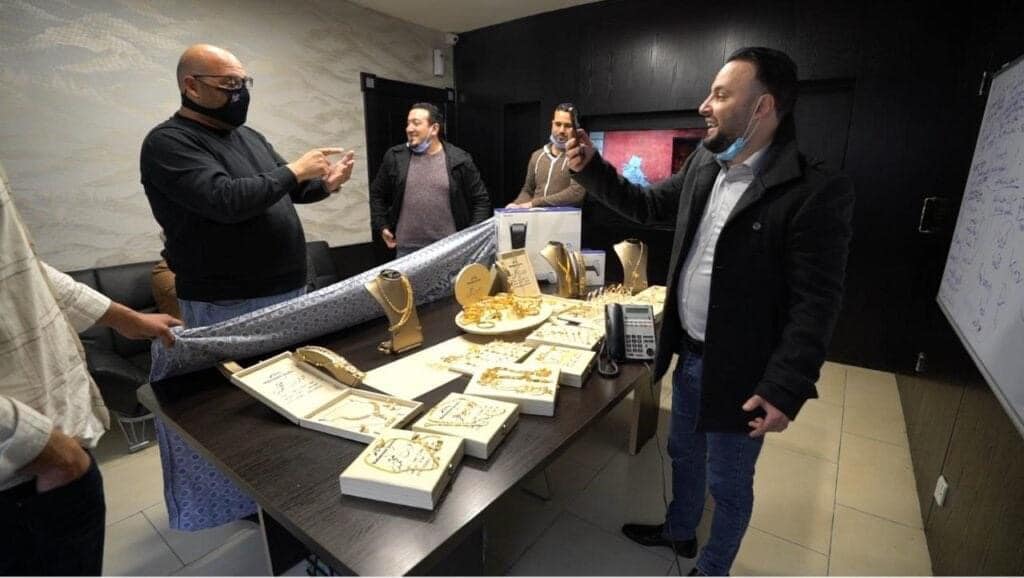A businessman hands out gold