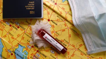 Fake blood is seen in test tubes labelled with the coronavirus (COVID-19) placed on the EU map and passport in this illustration taken March 17, 2020. (Reuters)