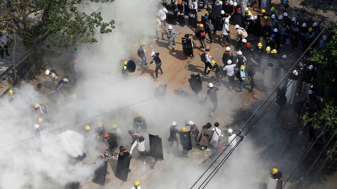 Protesters react as they engulfed by tear gas fired by police, and as other demonstrators let off fire extinguishers, during a demonstration against the military coup in Yangon on March 6, 2021. (File photo: AFP)