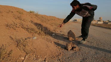 A resident points to what he said was a land mine, in the village of al-Heesha in Raqqa district after it was captured from Islamic State, north of Raqqa city, Syria November 15, 2016. REUTERS/Rodi Said