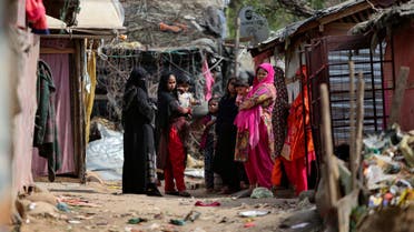  Rohingya refugees stand outside their makeshift camp on the outskirts of Jammu, India, Sunday, March 7, 2021. (AP)