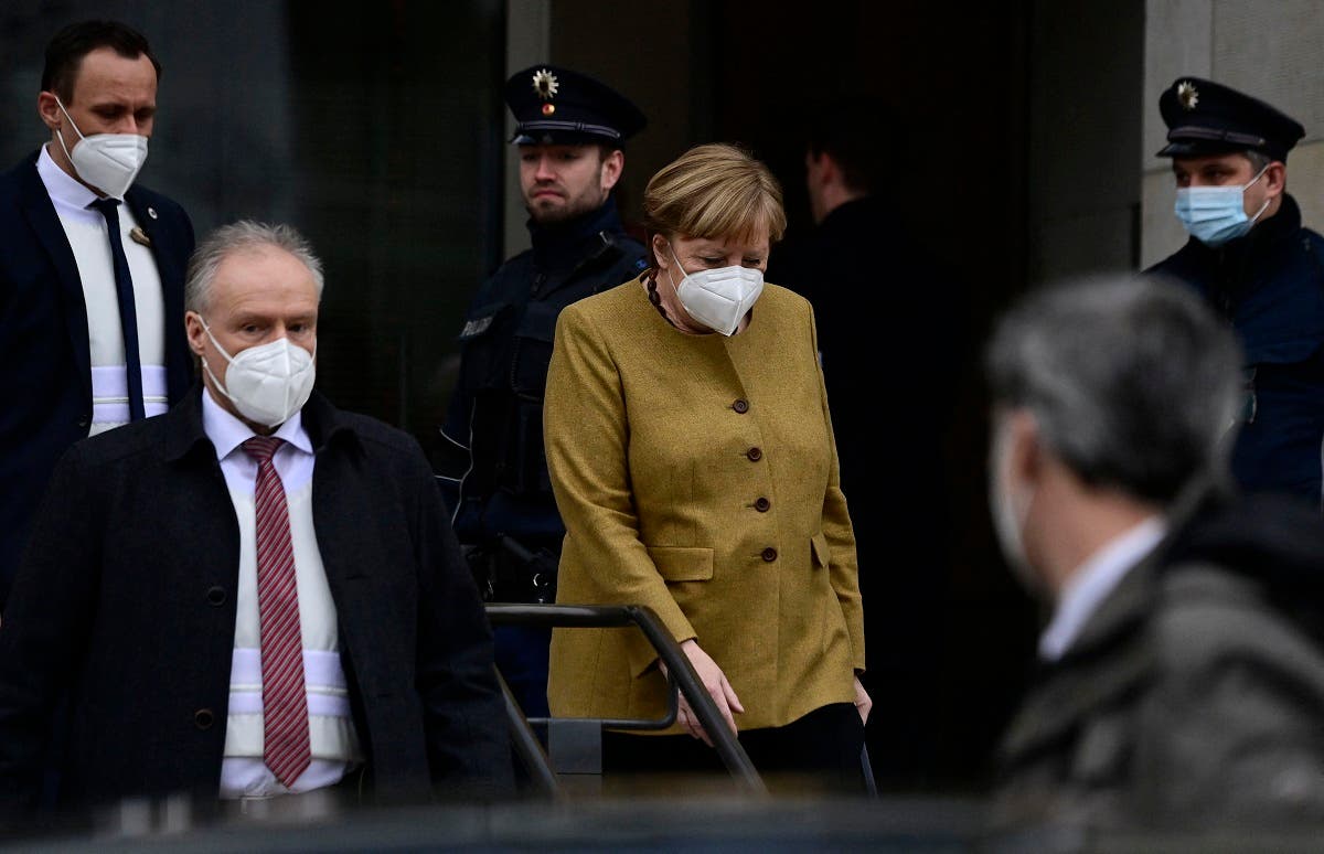 German Chancellor Angela Merkel (C) leaves the Reichstag building, seat of the German lower house of parliament Bundestag, during a session in Berlin on March 4, 2021. (Tobias Schwarz/AFP)