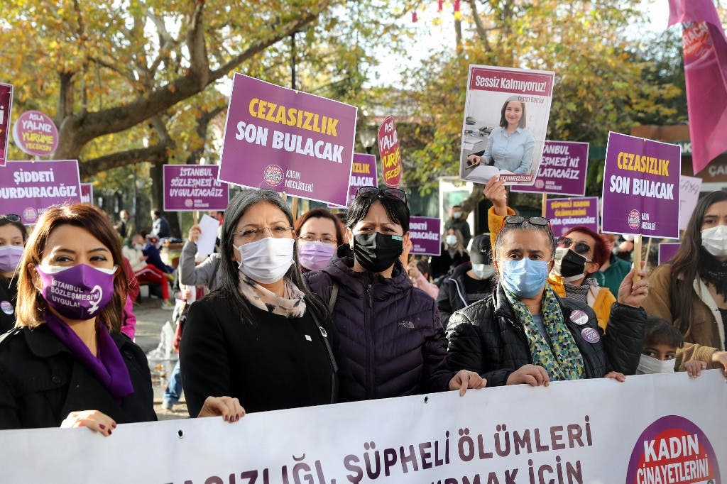 Members of KCDP (We Will Stop Femicides Platform - Kadin Cinayetlerini Durduracagiz Platformu) hold placards reading 'stop femicide' and 'We will enforce the Istanbul convention', during a protest for a better implementation of the Istanbul Convention and the Turkish Law 6284 for protection of the family and prevention of violence against women, in Ankara on November 22, 2020. (AFP)